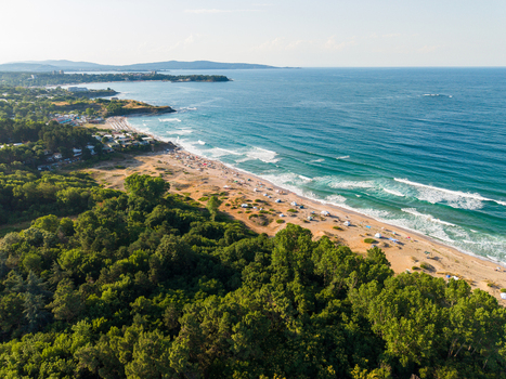 Aerial view of Coral Beach with its sandy shoreline turquoise sea waves and surrounding lush green forest along the coastline in Tsarevo Burgas Bulgaria. Aerial view of Coral Beach with its sandy shoreline turquoise sea waves and surrounding lush green forest along the coastline in Tsarevo Burgas Bulgaria.