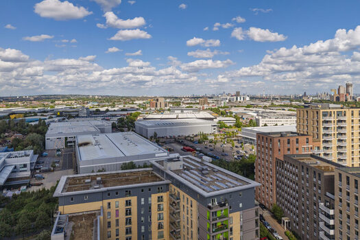 Aerial view of modern apartment buildings and industrial warehouses in London England United Kingdom. Aerial view of modern apartment buildings and industrial warehouses in London England United Kingdom.
