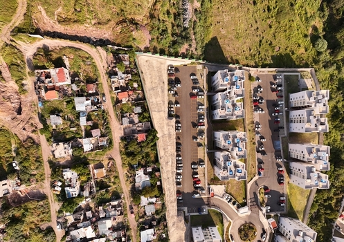 Santiago de Queretaro Queretaro Mexico 25 September 2026 Aerial view of Anillo Vial Fray Junipero Serra with modern apartment buildings parking lots and hilly terrain.