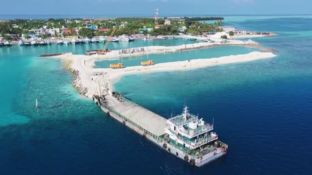 Aerial view of a cargo barge at a construction site Maldives. Aerial view of a cargo barge at a construction site Maldives.