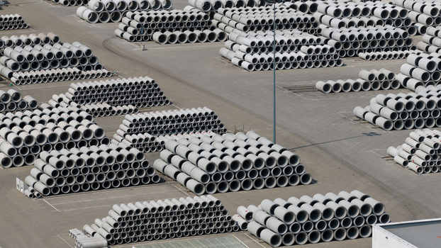 Aerial view of large stacks of concrete pipes organized in rows at an industrial storage yard in Oosterhout North Brabant Netherlands. Aerial view of large stacks of concrete pipes organized in rows at an industrial storage yard in Oosterhout North Brabant Netherlands.