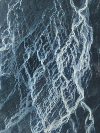 Aerial view of glacial rivers carving paths through the stark icy landscape a symphony of whites and blues blending in Iceland. Aerial view of glacial rivers carving paths through the stark icy landscape a symphony of whites and blues blending in Iceland.