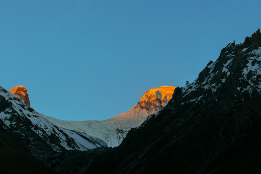 View of the snow covered peaks of the Karakoram range illuminated by the golden morning light at K2 Base Camp Gilgit Baltistan Pakistan. View of the snow covered peaks of the Karakoram range illuminated by the golden morning light at K2 Base Camp Gilgit Baltistan Pakistan.