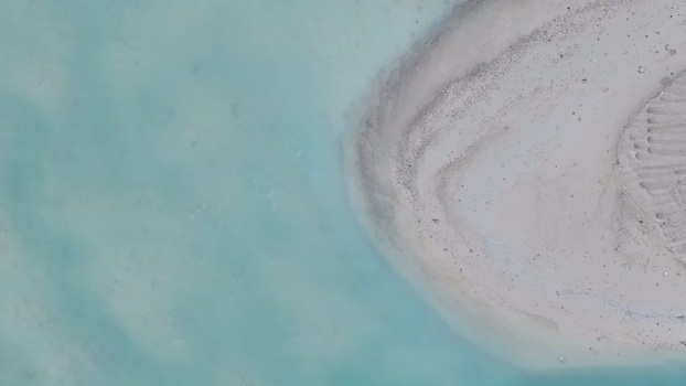 Aerial view of a white sandbar and turquoise water Maldives.