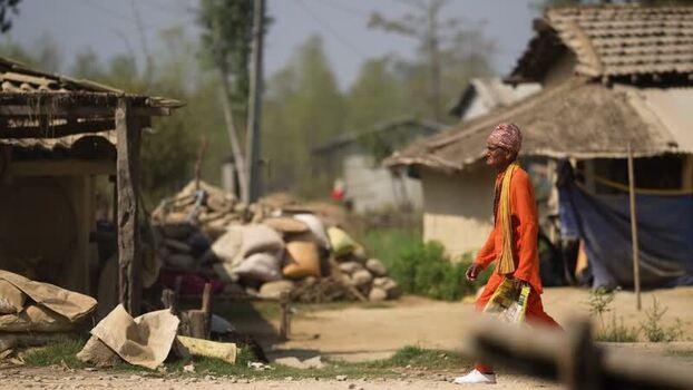 View of a man in traditional orange clothing walking Nepal. View of a man in traditional orange clothing walking Nepal.