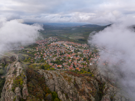 Aerial view of the Belogradchik Rocks surrounding the town of Belogradchik with red tiled rooftops rocky terrain and low hanging clouds in Belogradchik Vidin Bulgaria. Aerial view of the Belogradchik Rocks surrounding the town of Belogradchik with red tiled rooftops rocky terrain and low hanging clouds in Belogradchik Vidin Bulgaria.