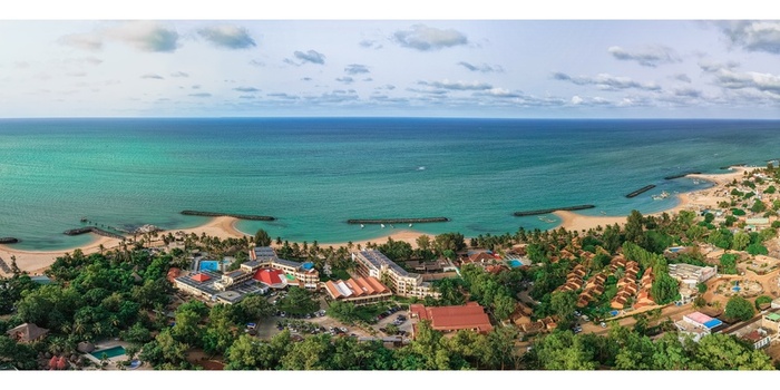Aerial view of the coastal resort of Saly with turquoise waters sandy beaches and luxury hotels nestled among palm trees and lush gardens in Saly Thies Region Senegal.