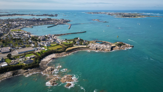 Aerial view of the rocky coastline embracing turquoise waters near the port and Île de Batz a dance of land and sea Roscoff Brittany France. Aerial view of the rocky coastline embracing turquoise waters near the port and Île de Batz a dance of land and sea Roscoff Brittany France.