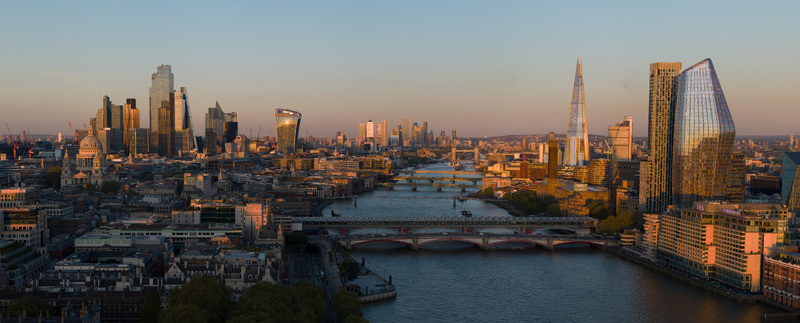 Aerial view of the London skyline and River Thames featuring St. Paul s Cathedral The Shard and Tower Bridge during a golden sunset London Greater London United Kingdom. Aerial view of the London skyline and River Thames featuring St. Paul s Cathedral The Shard and Tower Bridge during a golden sunset London Greater London United Kingdom.