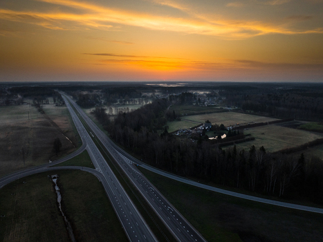 Aerial view of the A5 and A8 highway intersection at sunset with surrounding forests and fields in Olaine parish Olaine Municipality Latvia. Aerial view of the A5 and A8 highway intersection at sunset with surrounding forests and fields in Olaine parish Olaine Municipality Latvia.