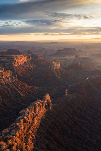 Aerial view of Bears Ears buttes and mesas in a dramatic desert landscape at golden hour with rugged rock formations and deep shadows in San Juan County Utah United States. Aerial view of Bears Ears buttes and mesas in a dramatic desert landscape at golden hour with rugged rock formations and deep shadows in San Juan County Utah United States.