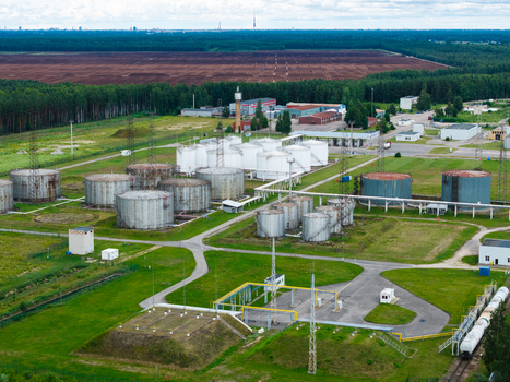 Olaine parish Latvia 04 July 2026 Aerial view of an industrial facility featuring numerous large storage tanks pipelines and surrounding green fields and forest. Olaine parish Latvia 04 July 2026 Aerial view of an industrial facility featuring numerous large storage tanks pipelines and surrounding green fields and forest.
