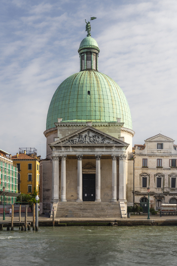 View of the San Simeone Piccolo church with its distinctive green copper dome and neoclassical facade situated along the Grand Canal in Venice Veneto Italy. View of the San Simeone Piccolo church with its distinctive green copper dome and neoclassical facade situated along the Grand Canal in Venice Veneto Italy.