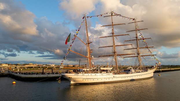 Aerial view of the tall ship NRP Sagres decorated with signal flags navigating the Canal de Aveiro near the salt pans Aveiro Aveiro Portugal. Aerial view of the tall ship NRP Sagres decorated with signal flags navigating the Canal de Aveiro near the salt pans Aveiro Aveiro Portugal.