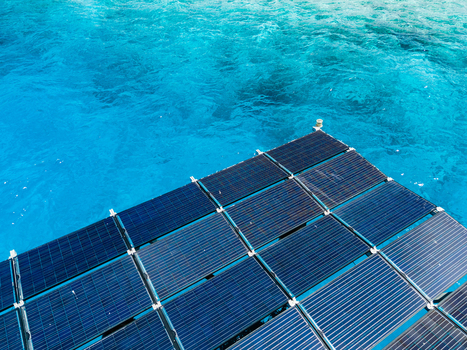 Aerial view of SolarSea floating solar power plant by Swimsol with dark blue panels on turquoise tropical water Dharavandhoo Baa Atoll Maldives. Aerial view of SolarSea floating solar power plant by Swimsol with dark blue panels on turquoise tropical water Dharavandhoo Baa Atoll Maldives.