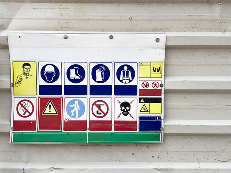 View of a construction safety sign board with various PPE icons mounted on a corrugated metal wall in Beylikduzu Istanbul Turkiye. View of a construction safety sign board with various PPE icons mounted on a corrugated metal wall in Beylikduzu Istanbul Turkiye.