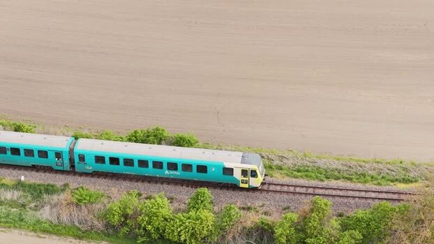 Aerial view of a turquoise Arriva train on tracks Czechia.