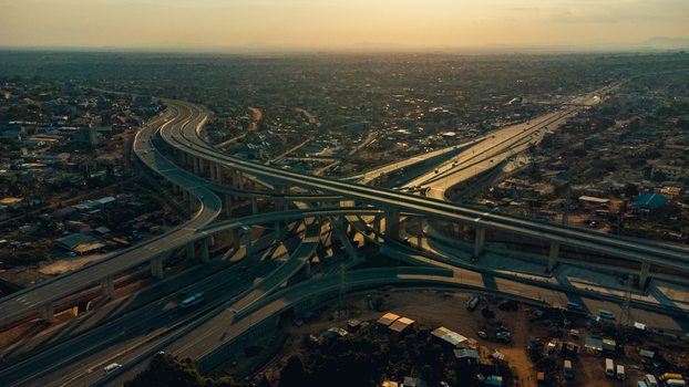 Aerial view of the Pokuase Interchange a multi level highway junction with sweeping concrete ramps surrounded by urban sprawl in Ga North Municipal Greater Accra Region Ghana. Aerial view of the Pokuase Interchange a multi level highway junction with sweeping concrete ramps surrounded by urban sprawl in Ga North Municipal Greater Accra Region Ghana.