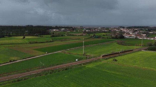 Aerial view of train passing fields Portugal.