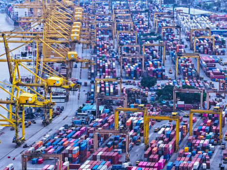 Aerial view of Chattogram Port featuring rows of colorful shipping containers and large yellow gantry cranes at the busy industrial terminal in Chittagong Chittagong Division Bangladesh.