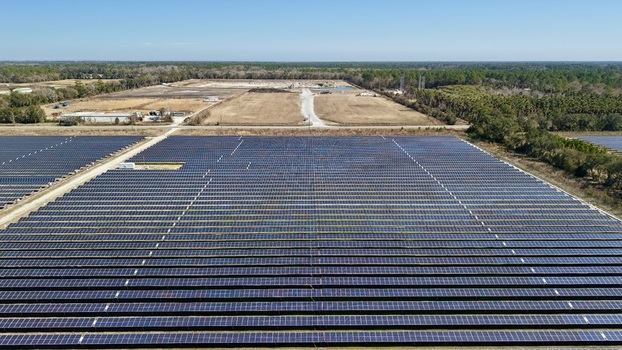 Aerial view of solar panels stretching towards the horizon where land meets the sky Elkton Florida United States. Aerial view of solar panels stretching towards the horizon where land meets the sky Elkton Florida United States.