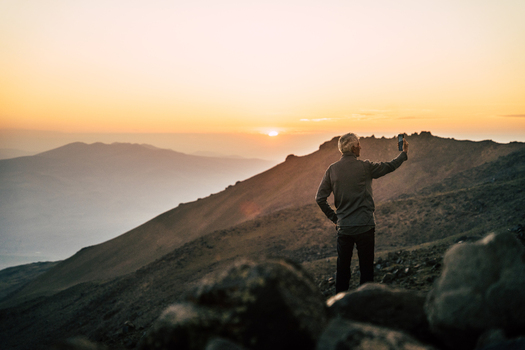 Turkey 14 August 2023 View of a man taking a photo with his smartphone on the rocky slopes of Mount Ararat during a golden sunset. Turkey 14 August 2023 View of a man taking a photo with his smartphone on the rocky slopes of Mount Ararat during a golden sunset.