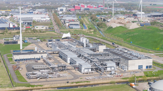 Aerial view of the Boekelermeer industrial facility featuring complex piping systems and large storage tanks under a clear sky in Alkmaar Noord Holland Netherlands. Aerial view of the Boekelermeer industrial facility featuring complex piping systems and large storage tanks under a clear sky in Alkmaar Noord Holland Netherlands.