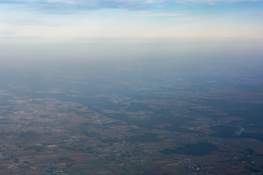 Aerial view of the landscape with a muted palette where earth and sky blend seamlessly showcasing a tranquil yet melancholic scene Warsaw Masovian Voivodeship Poland. Aerial view of the landscape with a muted palette where earth and sky blend seamlessly showcasing a tranquil yet melancholic scene Warsaw Masovian Voivodeship Poland.