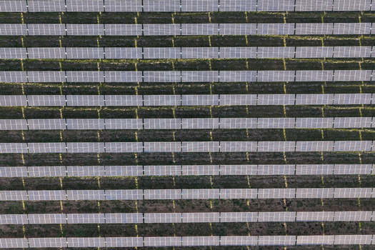 Aerial view of rows of solar panels in a large solar farm capturing the geometric pattern of the energy infrastructure in Woodburn Oregon United States. Aerial view of rows of solar panels in a large solar farm capturing the geometric pattern of the energy infrastructure in Woodburn Oregon United States.