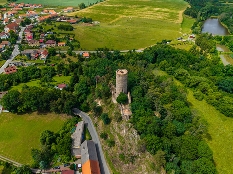 Aerial view of Tocnik Castle surrounded by lush green forests rolling fields and the nearby village in Tocnik Stredocesky kraj Czechia. Aerial view of Tocnik Castle surrounded by lush green forests rolling fields and the nearby village in Tocnik Stredocesky kraj Czechia.