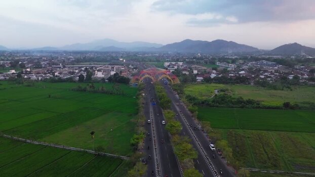 Aerial view of road with colorful arch in Mataram Indonesia.