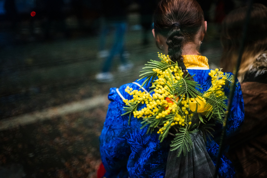 Basel Switzerland 10 March 2025 View of a vivid blue costume adorned with bright yellow flowers and lush green accents a vibrant spectacle against the dark urban backdrop. Basel Switzerland 10 March 2025 View of a vivid blue costume adorned with bright yellow flowers and lush green accents a vibrant spectacle against the dark urban backdrop.