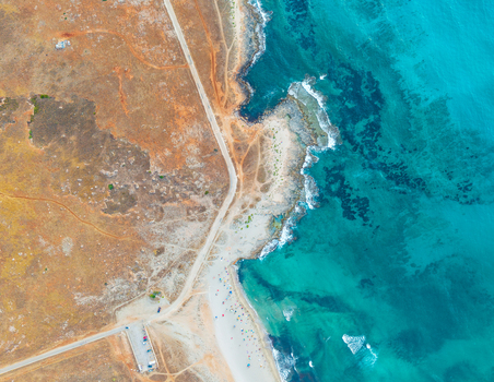 Aerial view of the rugged coastline with turquoise waters sandy beach and dry landscape near Palermo Sicily Italy. Aerial view of the rugged coastline with turquoise waters sandy beach and dry landscape near Palermo Sicily Italy.