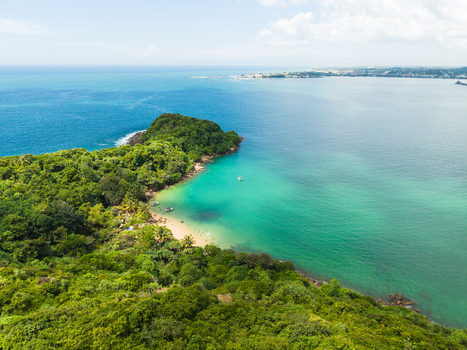 Aerial view of Jungle Beach surrounded by lush tropical forest and turquoise ocean water in Unawatuna Sri Lanka. Aerial view of Jungle Beach surrounded by lush tropical forest and turquoise ocean water in Unawatuna Sri Lanka.