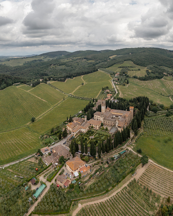 Aerial view of the historic Abbey of Passignano surrounded by lush vineyards cypress trees and rolling hills in Passignano Toscana Italy. Aerial view of the historic Abbey of Passignano surrounded by lush vineyards cypress trees and rolling hills in Passignano Toscana Italy.