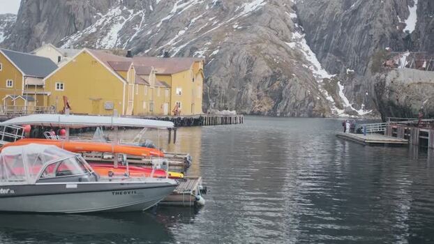 View of Nusfjord harbor with traditional yellow buildings Norway.