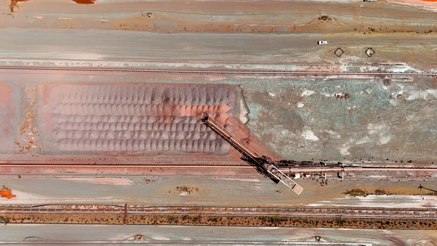 Aerial view of an industrial landscape with a large machine contrasting against the colorful mineral ponds Africa. Aerial view of an industrial landscape with a large machine contrasting against the colorful mineral ponds Africa.
