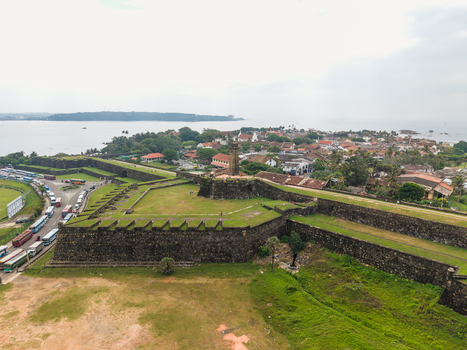 Aerial view of the historic Galle Fort with its massive stone walls and clock tower overlooking the coastal town and ocean in Galle Southern Province Sri Lanka. Aerial view of the historic Galle Fort with its massive stone walls and clock tower overlooking the coastal town and ocean in Galle Southern Province Sri Lanka.