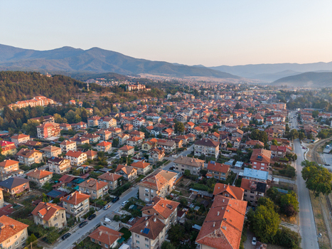 Aerial view of the residential town of Velingrad with its characteristic red tiled roofs winding streets and surrounding mountain landscape in Velingrad Pazardzhik Bulgaria. Aerial view of the residential town of Velingrad with its characteristic red tiled roofs winding streets and surrounding mountain landscape in Velingrad Pazardzhik Bulgaria.