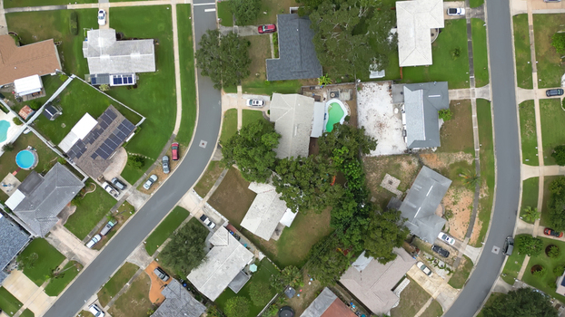 Aerial view of a residential neighborhood with houses swimming pools and lush trees in Clearwater Florida United States.