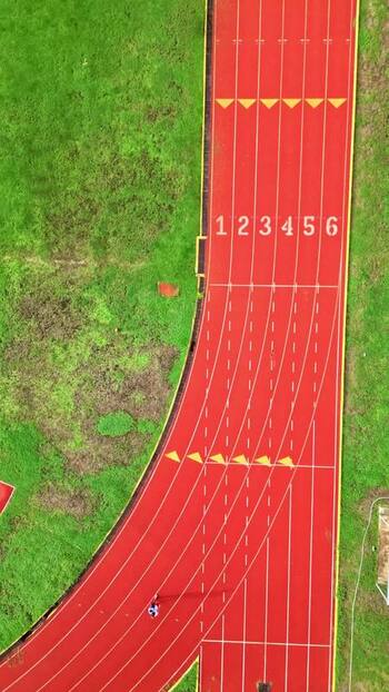 Aerial view of a red running track and green grass in Mexico. Aerial view of a red running track and green grass in Mexico.