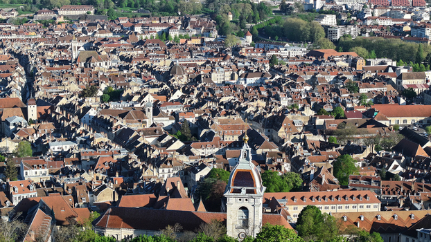 Aerial view of the dense historic rooftops and old stone architecture of the city center near the Besancon Citadel Besancon Bourgogne Franche Comte France. Aerial view of the dense historic rooftops and old stone architecture of the city center near the Besancon Citadel Besancon Bourgogne Franche Comte France.