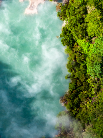 Aerial view of turquoise water swirling next to a vibrant green forest Waiotapu Thermal Wonderland Waikato Region New Zealand. Aerial view of turquoise water swirling next to a vibrant green forest Waiotapu Thermal Wonderland Waikato Region New Zealand.