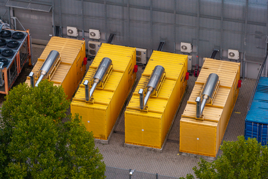 Aerial view of yellow industrial power generator containers at an AI data center facility in Warsaw Masovian Voivodeship Poland. Aerial view of yellow industrial power generator containers at an AI data center facility in Warsaw Masovian Voivodeship Poland.