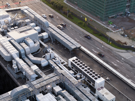 Aerial view of an AI data center rooftop featuring extensive HVAC ventilation systems and cooling units located next to a busy road with moving cars in Krakow Lesser Poland Voivode Poland. Aerial view of an AI data center rooftop featuring extensive HVAC ventilation systems and cooling units located next to a busy road with moving cars in Krakow Lesser Poland Voivode Poland.