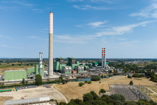 Aerial view of the TTEP Tavazzano thermal power plant and TERNA electrical substation with industrial chimneys and surrounding fields in Tavazzano con Villavesco Lombardy Italy.