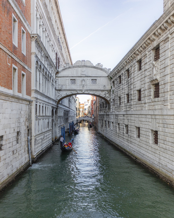 View of the Bridge of Sighs spanning the canal with a gondola passing underneath in Venice Veneto Italy. View of the Bridge of Sighs spanning the canal with a gondola passing underneath in Venice Veneto Italy.