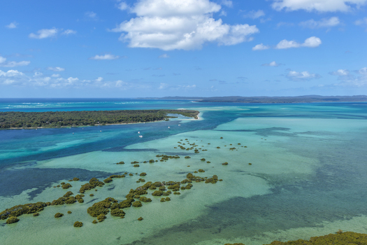 Aerial view of Moreton Island featuring shallow turquoise waters mangrove clusters and sandbanks near the coast of Kooringal Queensland Australia. Aerial view of Moreton Island featuring shallow turquoise waters mangrove clusters and sandbanks near the coast of Kooringal Queensland Australia.