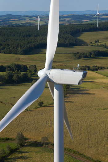 Aerial view of wind turbines standing tall amid the patchwork fields and forests a striking contrast of modern technology and natural beauty Salles Curan Occitanie France. Aerial view of wind turbines standing tall amid the patchwork fields and forests a striking contrast of modern technology and natural beauty Salles Curan Occitanie France.