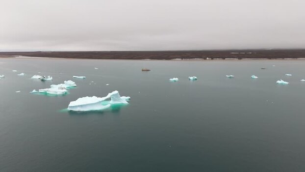 Aerial view of icebergs floating near Disko Island Greenland. Aerial view of icebergs floating near Disko Island Greenland.